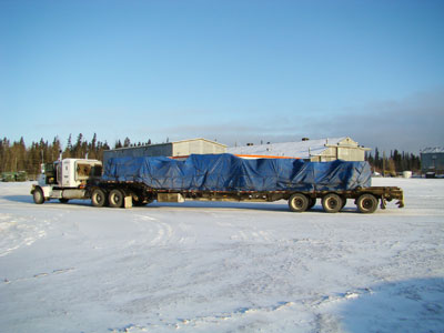 Tarped load of steel rims for big ore trucks in Fort McMurray Alberta